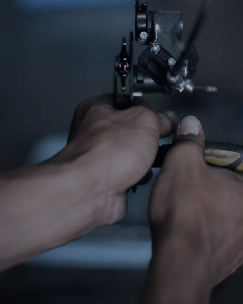 Illustrative example: first-person view of two hands working at a sewing machine.